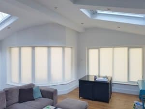 Signature pleated blinds are a wonderful way to dress a rounded bay window