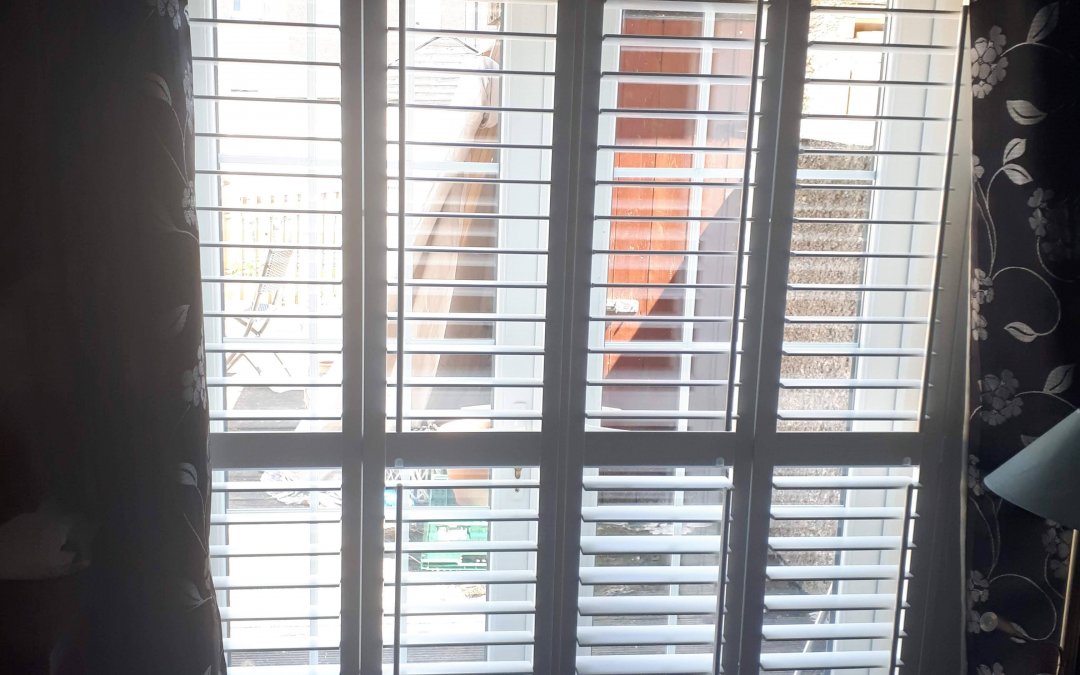 Plantation Shutters fitted onto patio doors and a kitchen window.