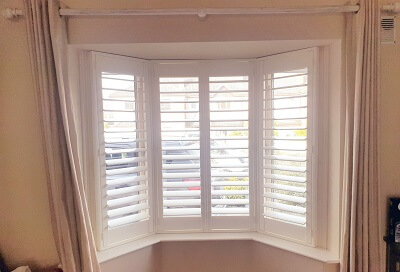 White Shutters on a bay Window in Dun Laoighre. Shutters with L-Frame in Dublin.