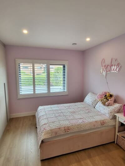 White Plantation Shutters for a Beautiful Pink Bedroom in Dublin